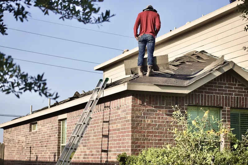 Professional roofer working on a residential roof in Central Oak Park